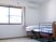 サムネイル 施設の写真 エアコン付きのフローリングの居室には寝具付きのベッドがあり、大きな窓にはカーテンが付き、家具などは置かれていない。