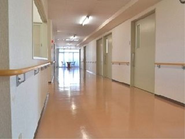 明るい廊下の手すり 廊下 手すりが設置された明るく清潔感のある廊下です。ゆったりとしたスペースで安全に移動できる環境が整っています。