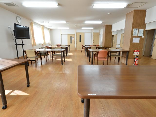 広々としたダイニングルーム 食堂のテーブル 明るく清潔感のあふれる食堂です。利用者が集い、食事やコミュニケーションを楽しむ場所となっています。