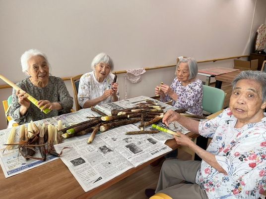 リビングにて新聞を読む方