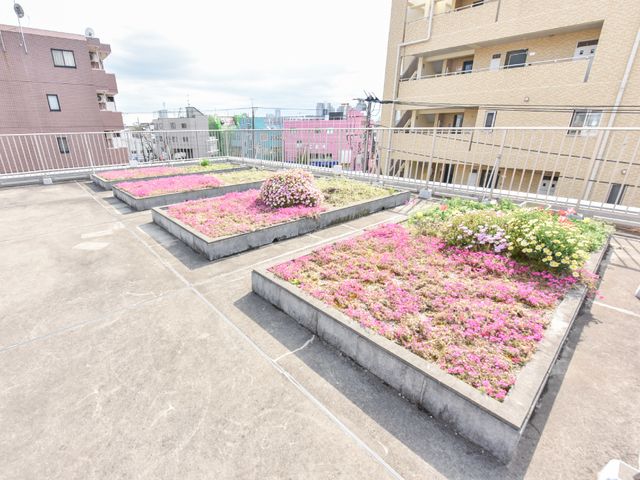 屋上庭園の花壇 屋上 屋上に設けられた明るい花壇が、日々の憩いの場を提供します。自然に囲まれた環境で心穏やかに過ごせる空間です。