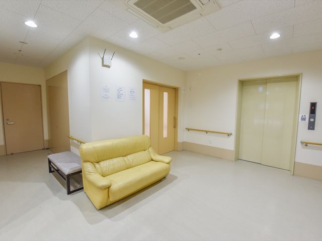 廊下の応接セット エレベーターホール 明るく清潔感がある休憩コーナーです。落ち着いた色合いのソファで、ゆったりとした一時を過ごせます。