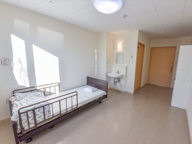 居室の清潔な空間 居室 広々とした明るい個室で、必要な設備が整っており、快適なプライバシー空間をお約束します。ベッドサイドには個人の時間を大切にしやすい照明が設けられています。