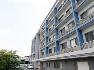 青いアクセントのある居室外観