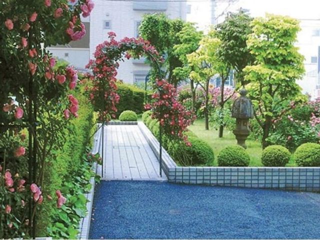 緑と花が映える中庭 エントランス 四季折々の花々に囲まれた、落ち着いた雰囲気の中庭です。日々のリフレッシュに最適な空間を提供しています。