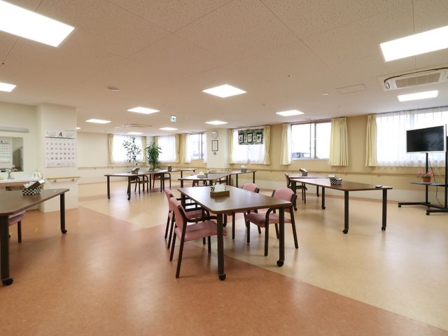 広々とした明るい食堂 リビング 広々とした食堂は椅子とテーブルが整然と配置され、心地よい採光があります。窓際の植物が空間に温もりを添えています。