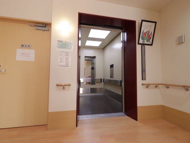 廊下の開いたエレベーター エレベーター  手すりが備えられた廊下と、車いすの方も利用しやすいエレベーター。快適な移動をサポートします。