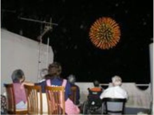 夜空の花火を見る人々