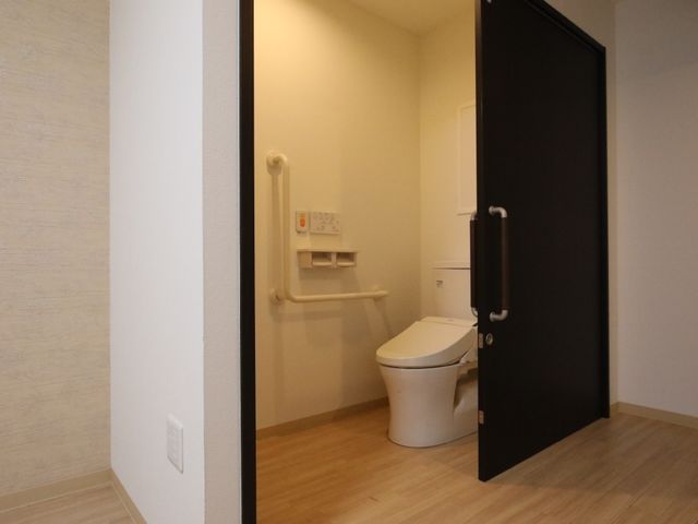 バリアフリー設計のトイレ 居室 手すり付きで安全に配慮されたきれいなトイレです。入退室しやすいため、働きやすい環境が整っています。