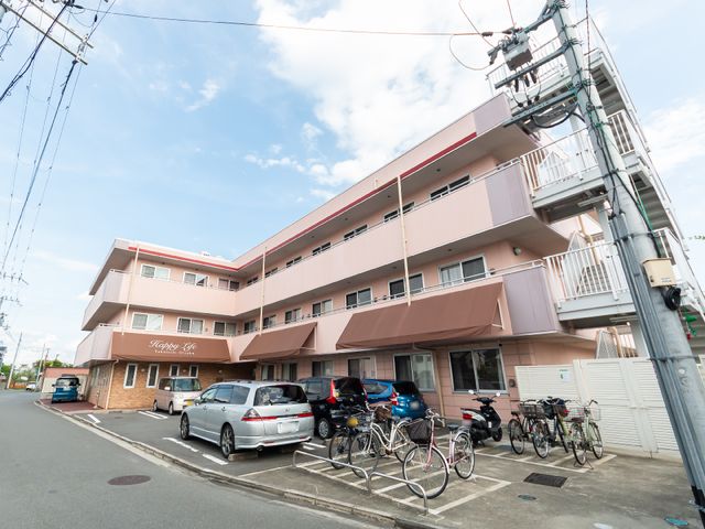 ピンク色の外壁の建物 外観 ピンク色の外壁が印象的な快適そうな建物です。スタッフのイメージも穏やかな職場環境を予感させます。