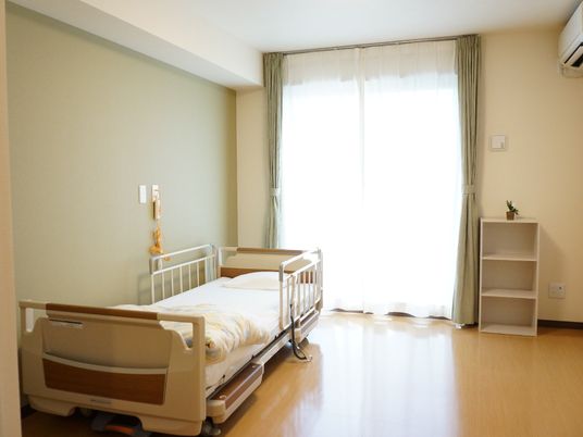 明るい居室のベッドと棚