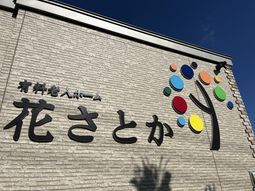 カラーの看板がある外観
