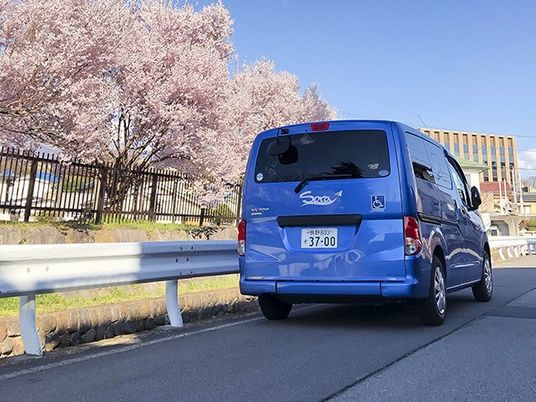 送迎車と桜並木の外観  