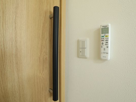 木目調の扉とエアコンリモコン