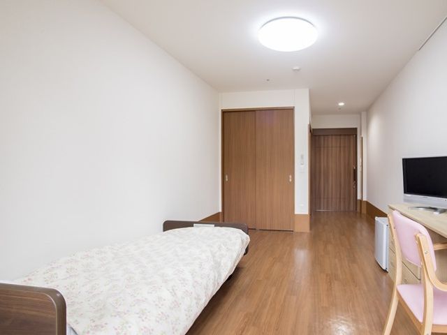 シンプルな個室の居室 居室 落ち着いた色合いの居室で、ゆったりとした個人の時間をお過ごしいただけます。清潔感のある広々とした空間が特徴です。