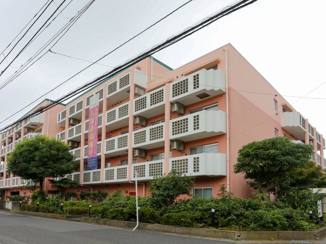 ピンクの建物外観 外観 清潔感のあるピンク色を基調とした建物です。落ち着いた環境の中で、あなたの力を活かしませんか。