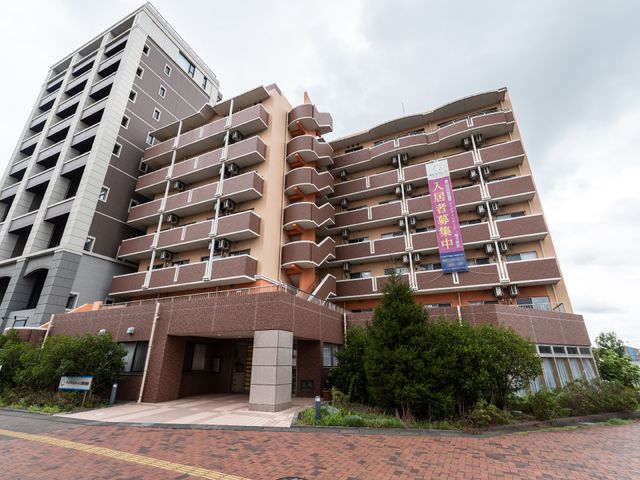多階層の建物外観 外観 ゆったりとしたエントランスが特徴の建物で、居心地の良い環境が整っています。ここでの勤務は、快適な職場環境を提供します。