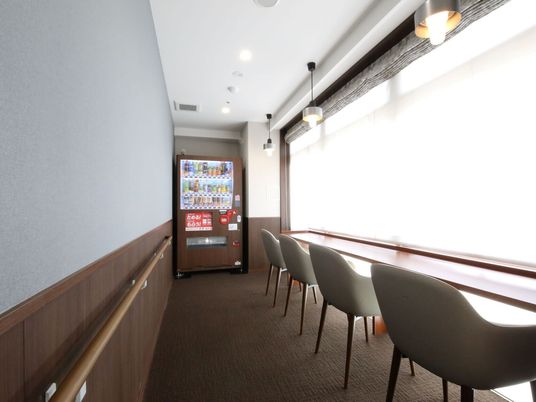 飲料自動販売機と窓側の椅子
