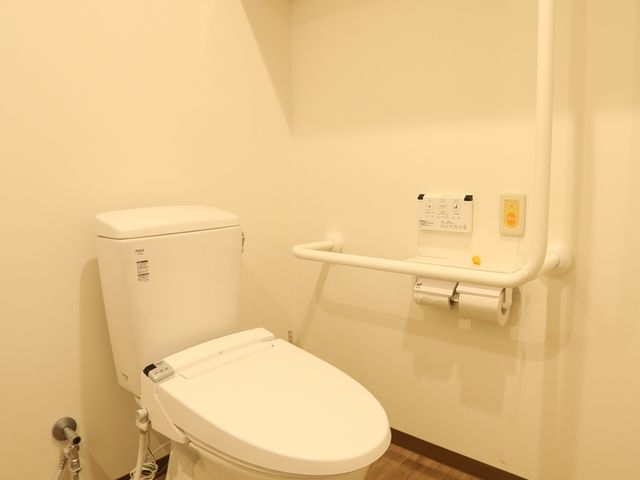 バリアフリートイレ設備 トイレ 安全に配慮された手すりを備えた清潔なトイレ。利用者の快適さと利便性を優先して設計されています。