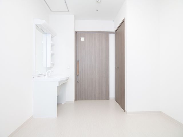 シンプルな洗面台と扉 居室 清潔感のある洗面スペースです。この環境でのお仕事、快適な毎日を支えてみませんか。