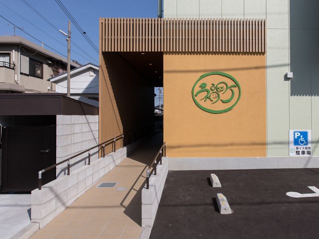 モダンなエントランス エントランス 新しい施設の入口は、無駄のないシンプルなデザインで迎えています。段差のない設計でどなたでも安全に出入りできます。