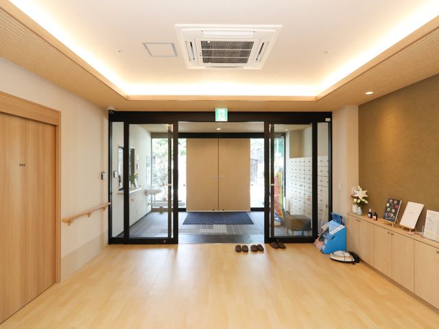 明るいエントランスホール 玄関 清潔で開放感のあるエントランスです。手すりや休憩スペースも整っており、訪れる方を優しく迎えます。