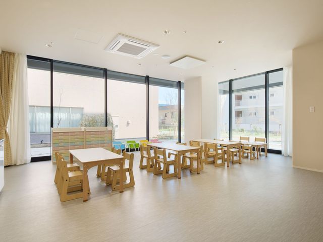 共有スペースの明るい居室 居室 ゆとりある居室で、窓からは自然光が差し込み、明るい印象を与えています。車椅子でも使いやすいテーブルや椅子が配され、居心地の良さを感じさせます。