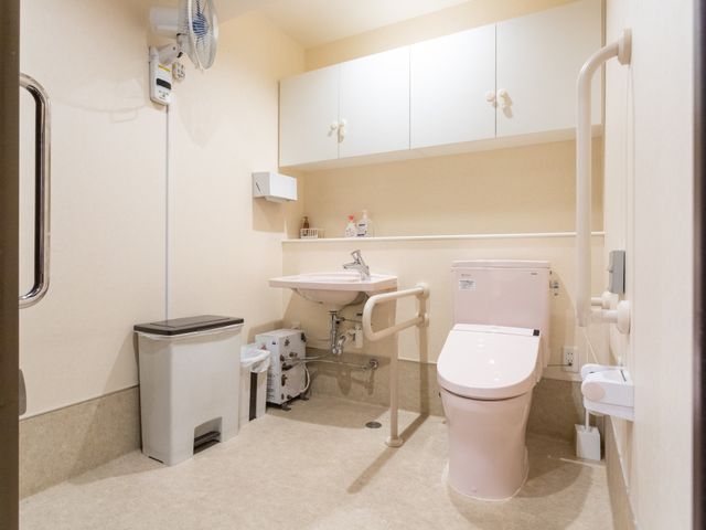 広々としたトイレ トイレ 広く設計されたトイレです。手すりが備え付けられており、安全に使用できます。