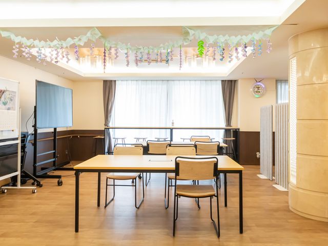 明るい室内空間のラウンジ ラウンジ 窓から入る自然光で、広々とした空間が柔らかく照らされています。利用者がゆったりと過ごせる配置です。