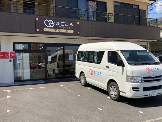 白い車が停まる建物前