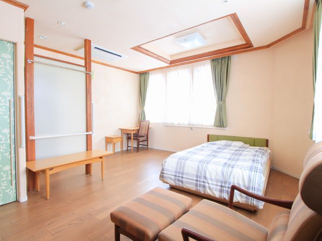 清潔な個室の居室 居室 ゆったりとした設計の居室です。木の温もりが感じられるフローリングと、日の光が優しく差し込む窓が心地よい空間をつくり出しています。