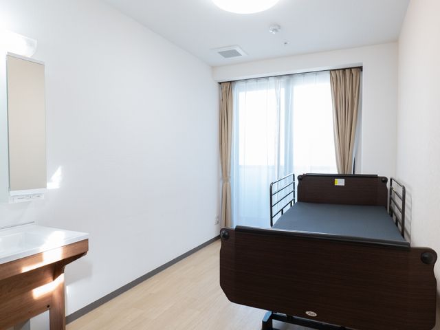 明るい単身用居室 居室 シンプルで機能的な単身用のお部屋です。余計なものがなく、落ち着いた雰囲気でお過ごしいただけます。