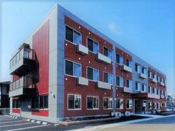 赤とグレーの建物外観