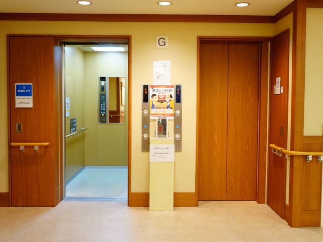 エレベーター付近の廊下 エレベーター 明るい色調の廊下には手すりが設けられ、エレベーターも備わっており、安全に配慮された設計です。