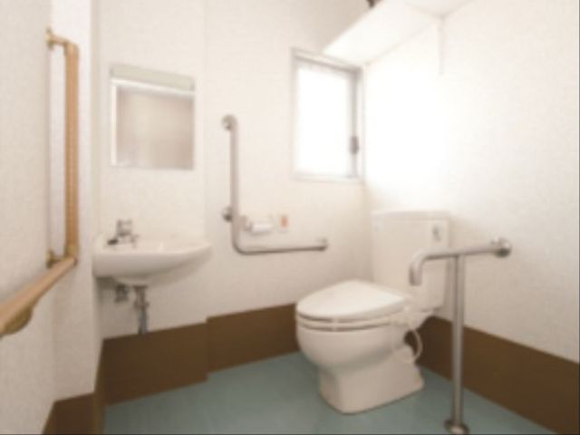 バリアフリー設計のトイレ トイレ 手すりが設置された清潔感のあるトイレで、安心してお使いいただける環境です。ゆったりとしたスペースで快適にご利用可能です。