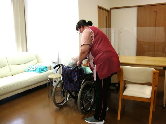 介助者と車椅子の高齢者