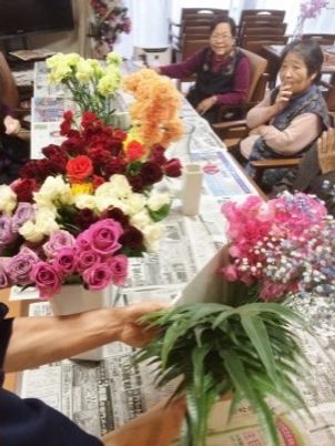花束を手にする人々