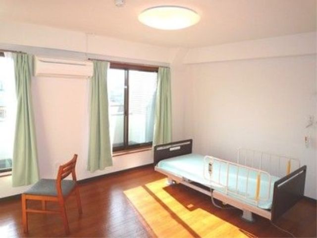 居室の清潔な空間 居室 この居室は明るく広々としており、大きな窓からの自然光が心地よい環境を作り出しています。家具の配置も余裕があり、快適にお過ごしいただけるでしょう。
