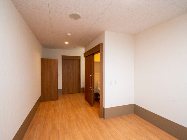 清潔な居室の様子 居室 落ち着いた色合いの居室は、快適に過ごせる広々とした空間となっており、日々の生活をサポートする環境です。