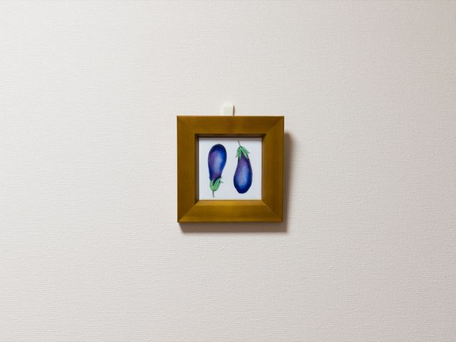 壁に掛けられた絵 絵画 シンプルで落ち着いた雰囲気の部屋の一角です。壁には美しい絵が飾られ、訪れた人に穏やかな印象を与えます。
