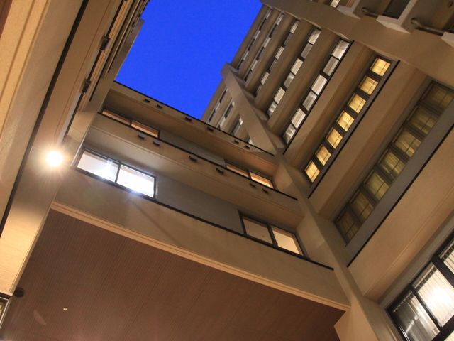 夜空と建物の中庭 外観吹き抜け 夜の時間帯でも安らぎを感じられるよう、明るく照らされた屋外の空間です。こちらで星空を眺めながらのひと時をお過ごしいただけます。