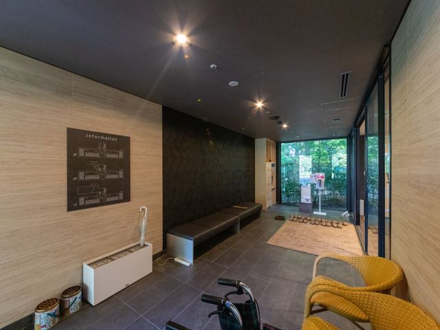 明るいエントランスの待合 エントランス   木目調の落ち着いた待合スペースです。ガラス越しに緑が見え、来訪時の印象がやわらかい空間です。