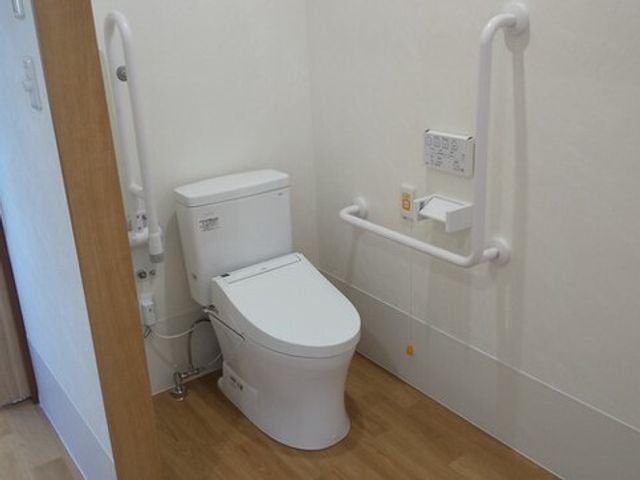 手すり付きのトイレ トイレ 手すりが周囲に備わったトイレで、安全性に配慮した設計です。利用者の自立を支援する環境を整えています。