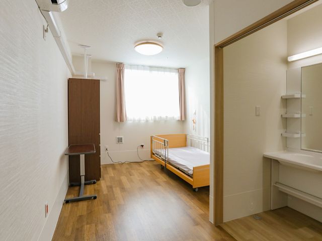 明るい個室の居室 居室 清潔感あふれる居室が、安心の就業環境を提供します。利用者の快適な生活をサポートするための設備が整っています。