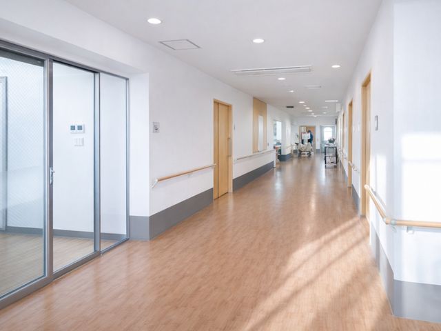 明るい廊下 廊下 広々とした通路で、手すりが設置され安心して移動できます。自然光が差し込む開放的な空間です。