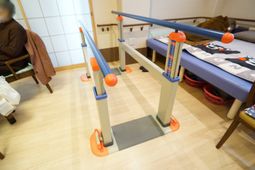 歩行訓練器具と休憩する人