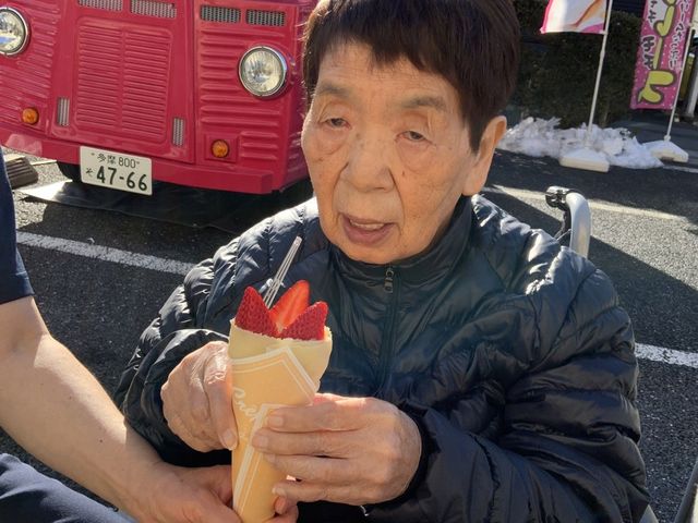 おやつのサービス準備中 中庭 屋外にておやつの提供を行うスタッフのサポートが見られます。お客様の喜びを直接感じられるやりがいのあるお仕事です。