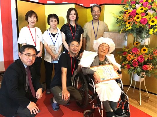 笑顔のスタッフと利用者が写る