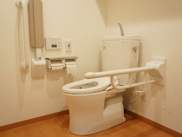 バリアフリーなトイレ設備 共有トイレ 手すり付きで安全性に配慮された清潔なトイレ空間です。利用者の日々の快適さを支える環境が整っています。