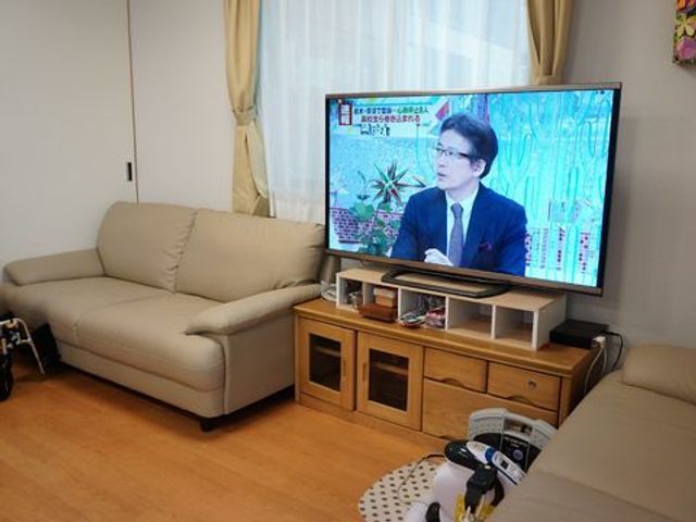 快適な居室空間 リビングダイニング一角 ゆったりとしたソファが置かれ、大画面テレビでのくつろぎ時間を提供しています。利用者のリラックスを支える配慮が感じられる居住空間です。